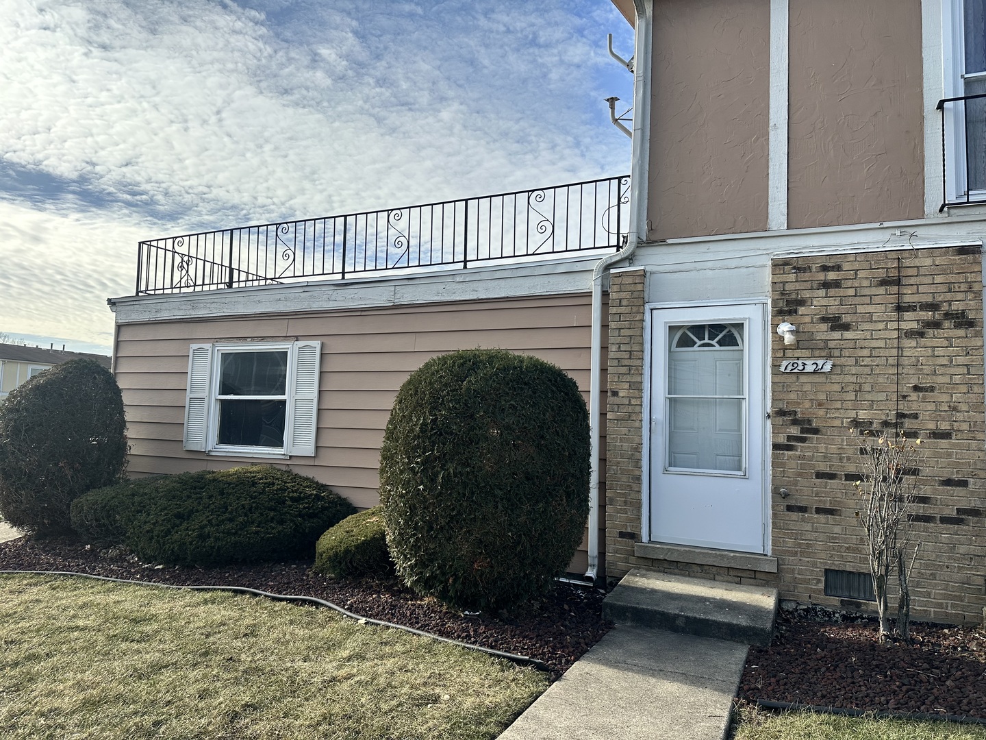 a view of a house with a small yard and a large window