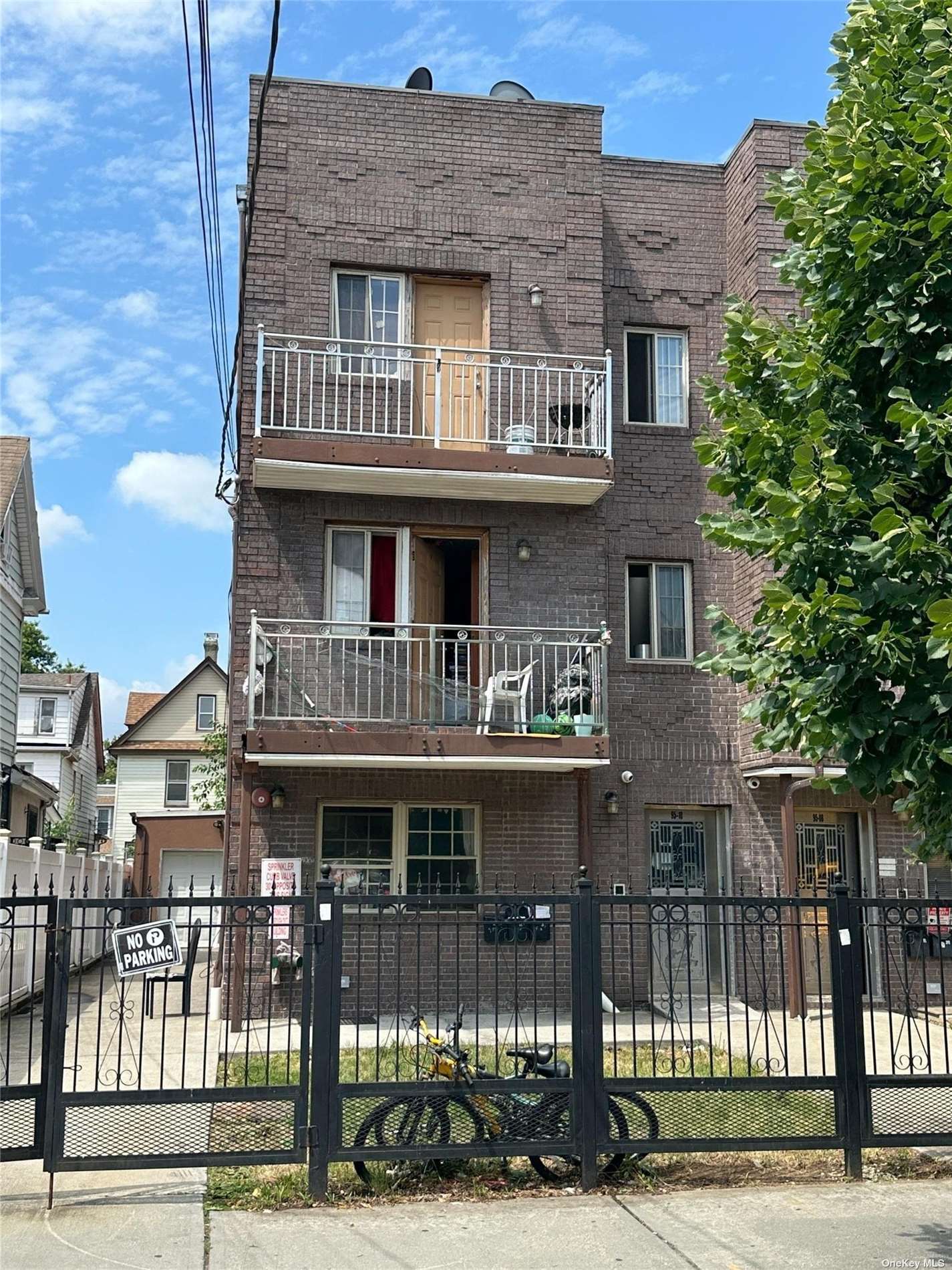 a front view of a residential apartment building with a yard