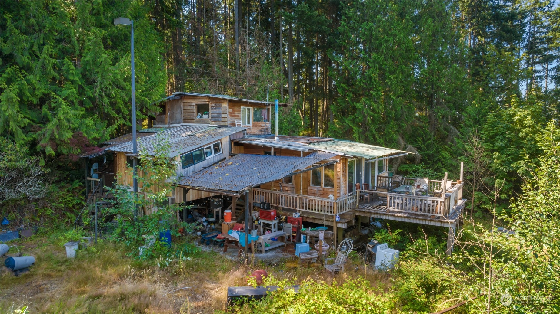 an aerial view of a house with swimming pool patio and deck