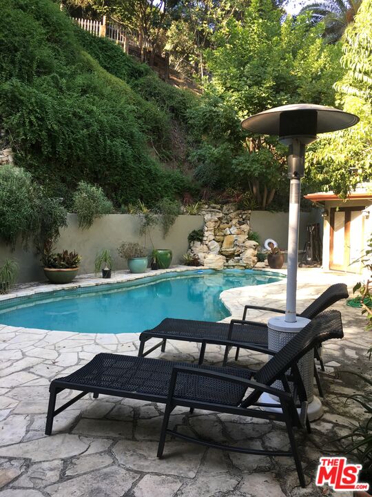 a view of a chairs and table in the patio