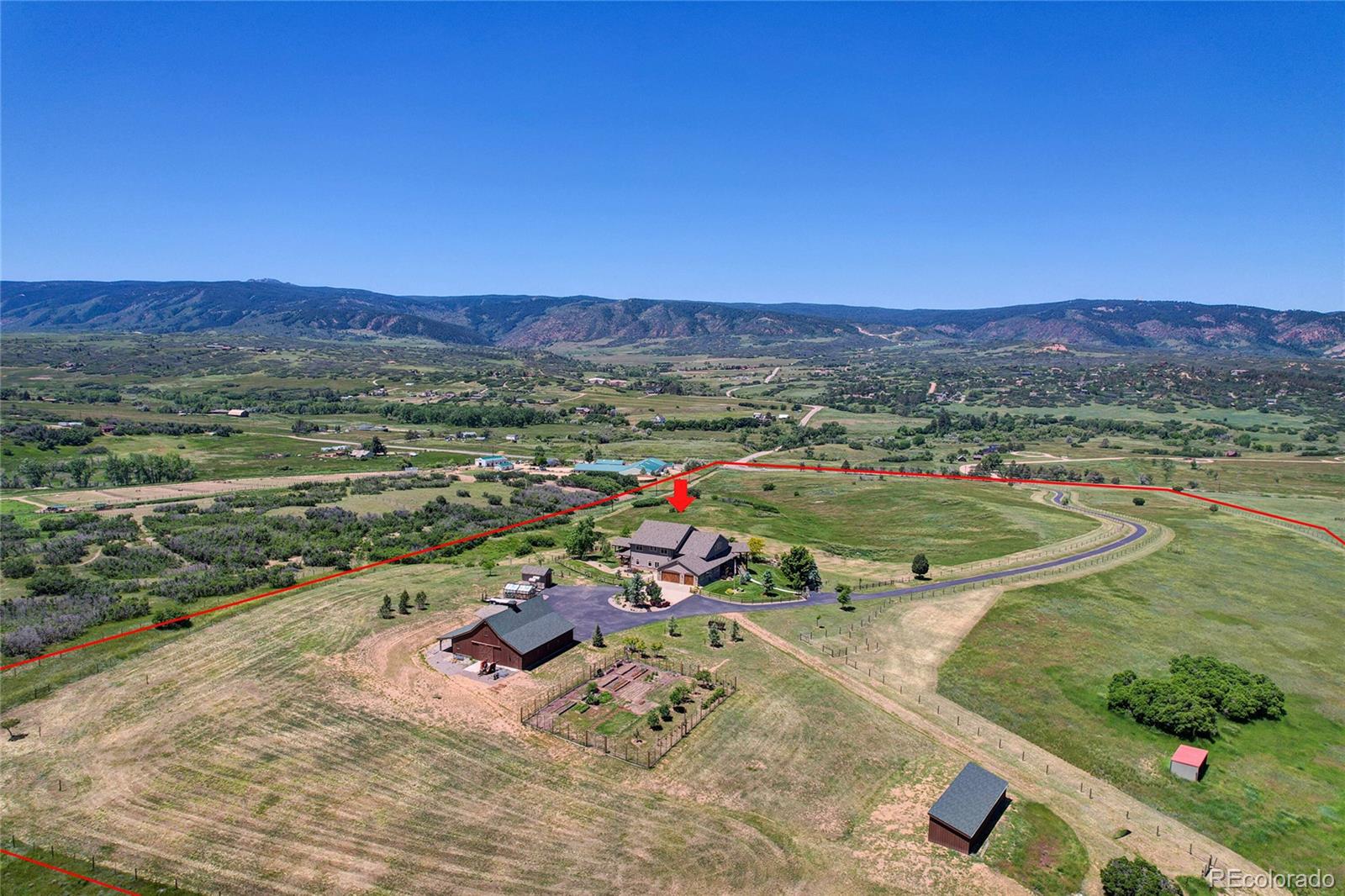 an aerial view of a houses with a yard