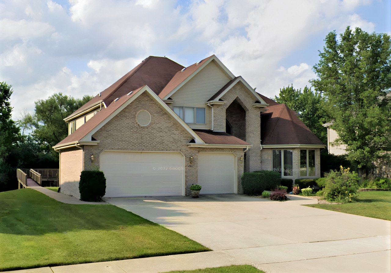 a front view of a house with garden