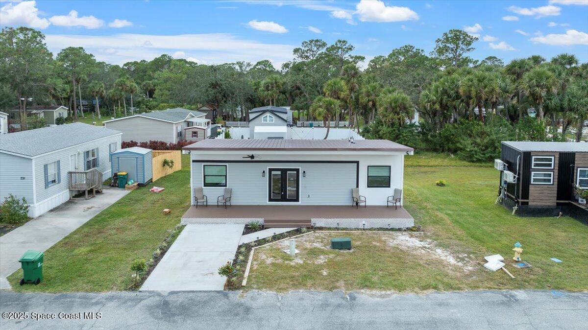 a view of a house with garden and deck