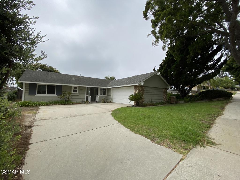 a front view of house with a garden