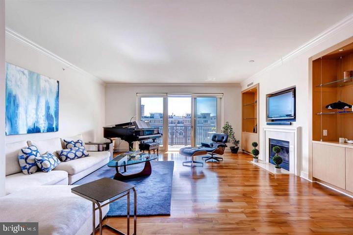 a living room with furniture large window and a fireplace