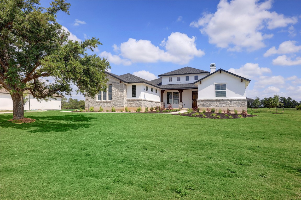 a front view of a house with a garden