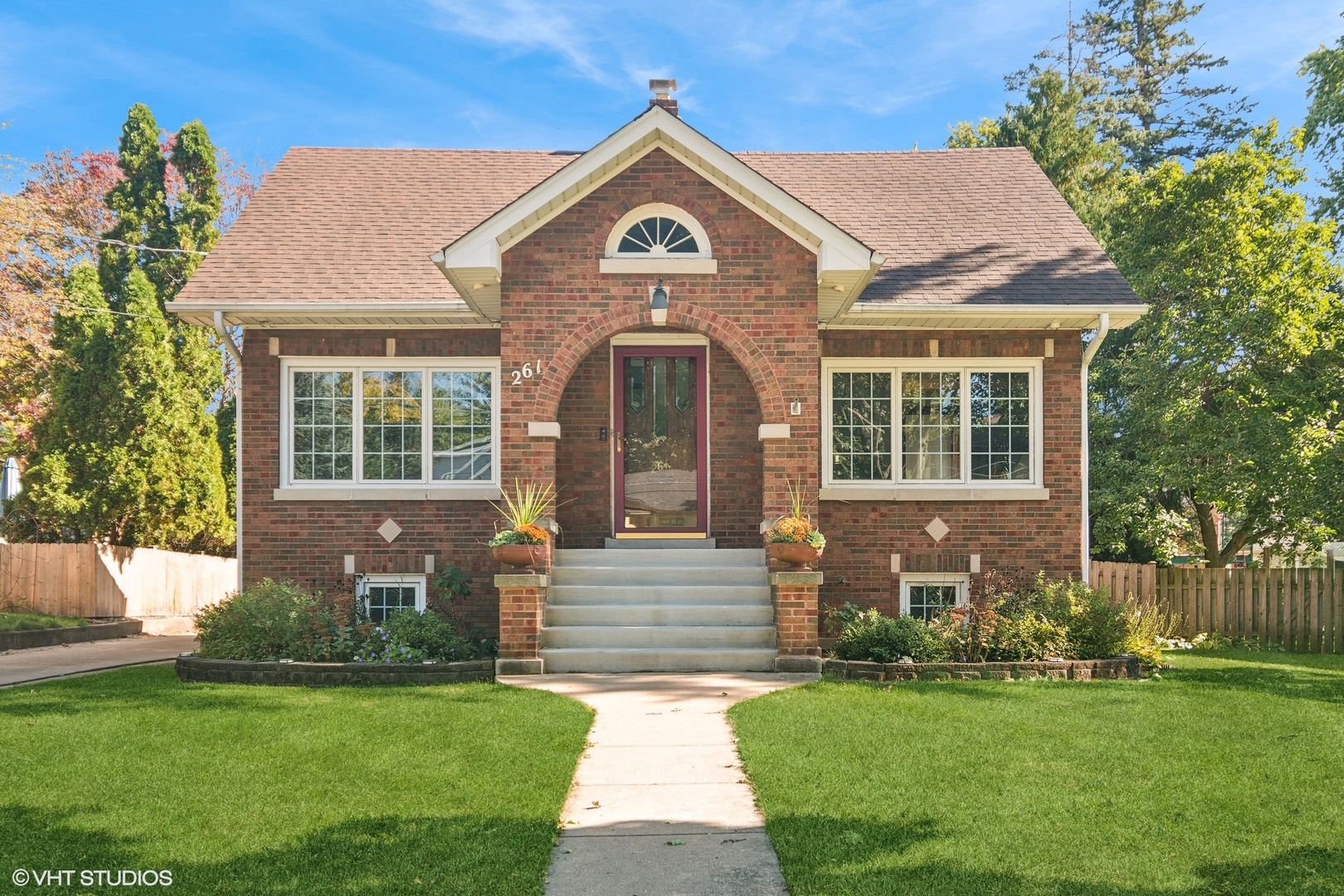 a front view of a house with a garden