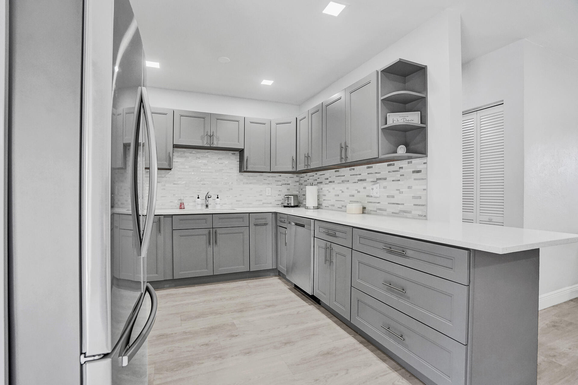 a kitchen with a sink refrigerator and cabinets