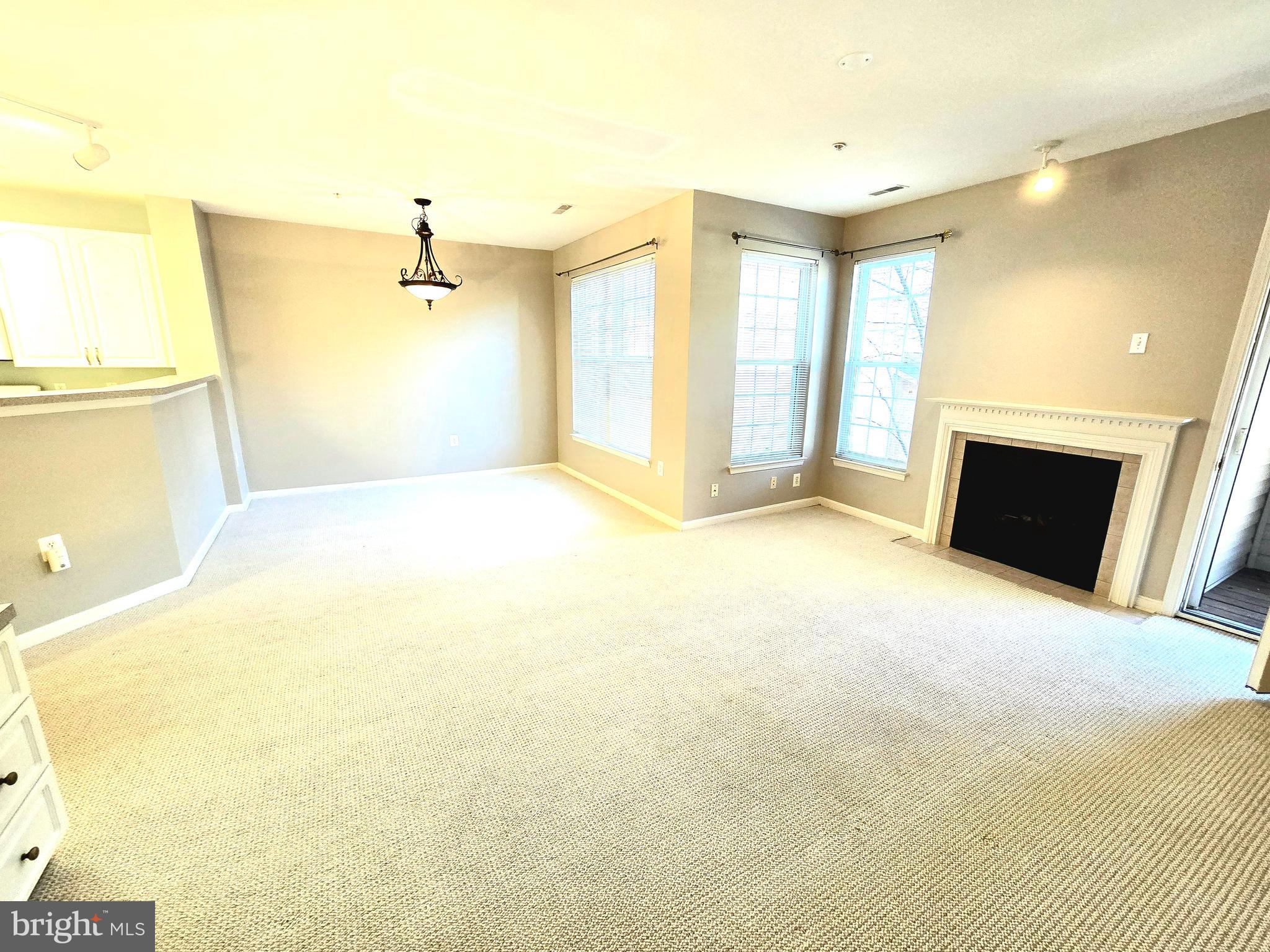 a view of an empty room with a fireplace