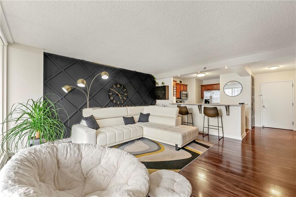 a living room with furniture and wooden floor