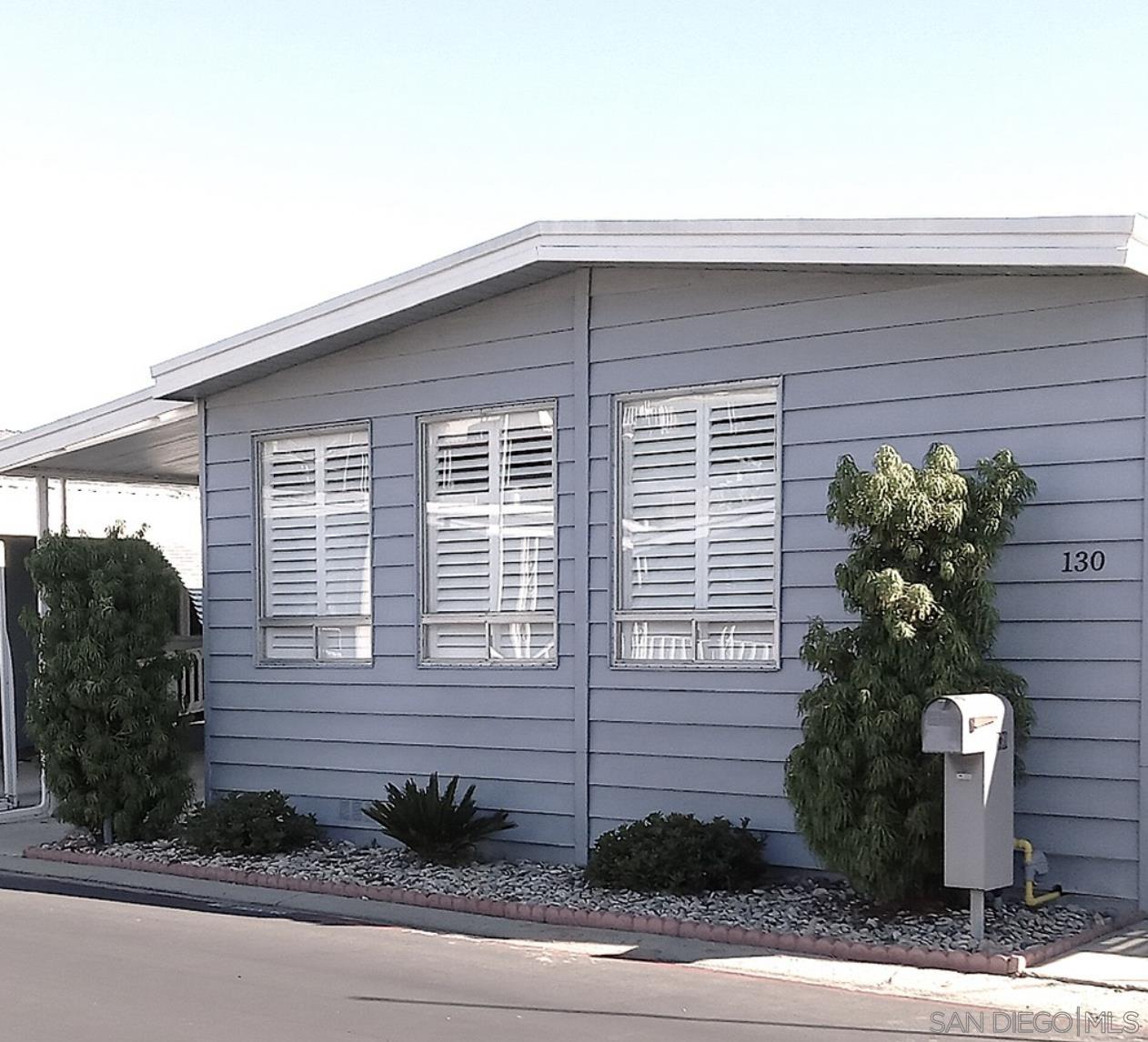 a view of a house with a yard and plants