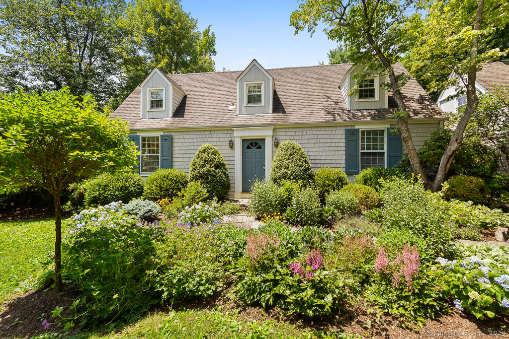 Beautiful perennial gardens welcome you to this warm and well-maintained cape.