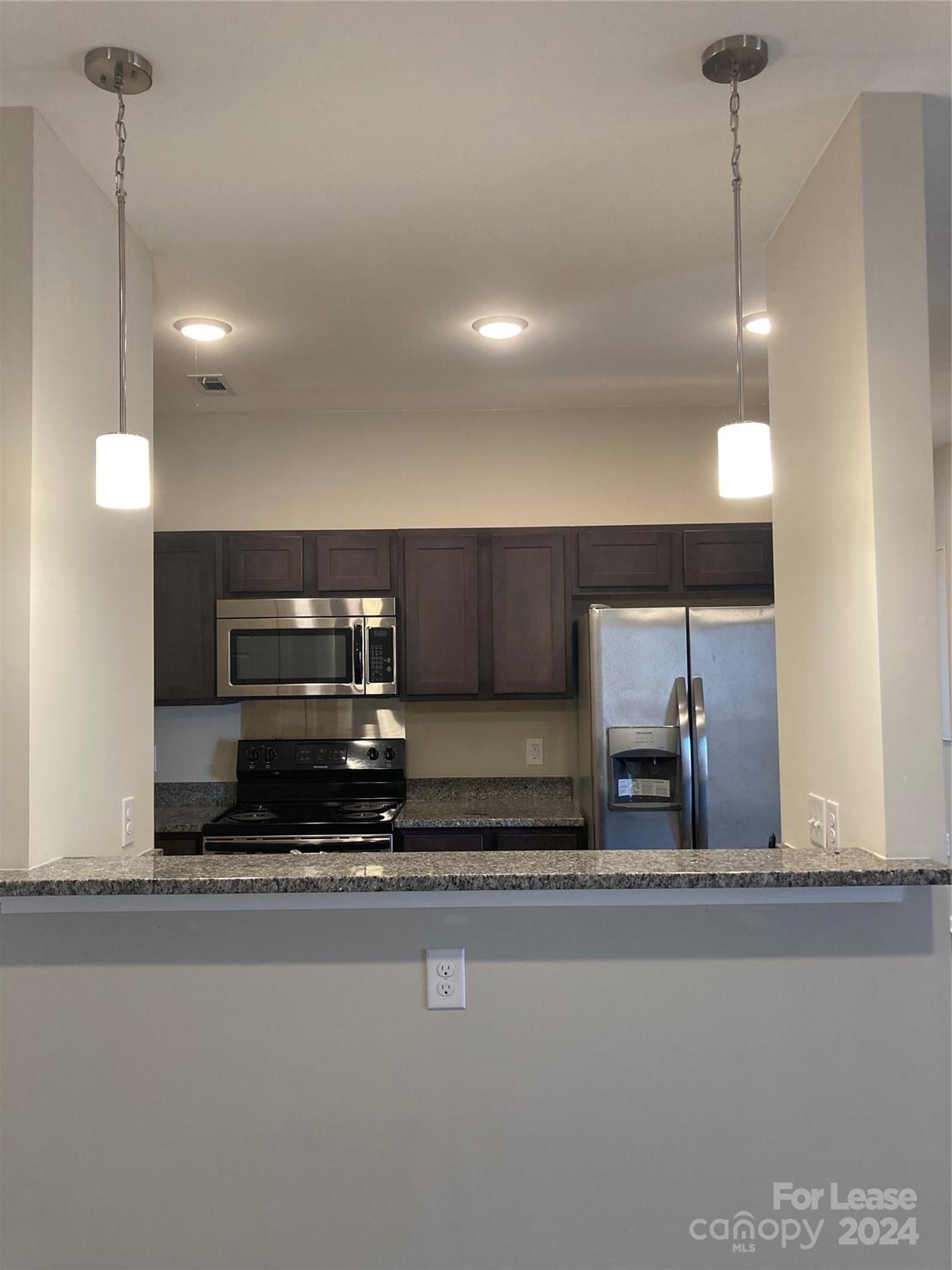 a view of a refrigerator a counter top space