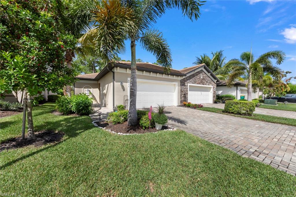 Ranch-style home featuring a front yard and a garage