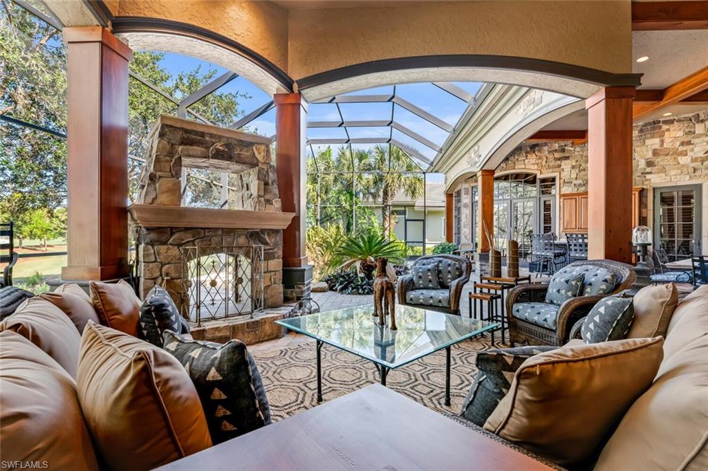 a living room with fireplace furniture and a large window