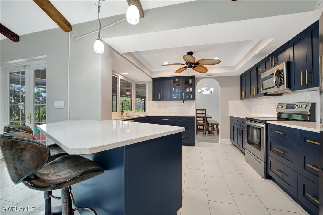 a kitchen with stainless steel appliances granite countertop a sink dishwasher stove refrigerator and cabinets