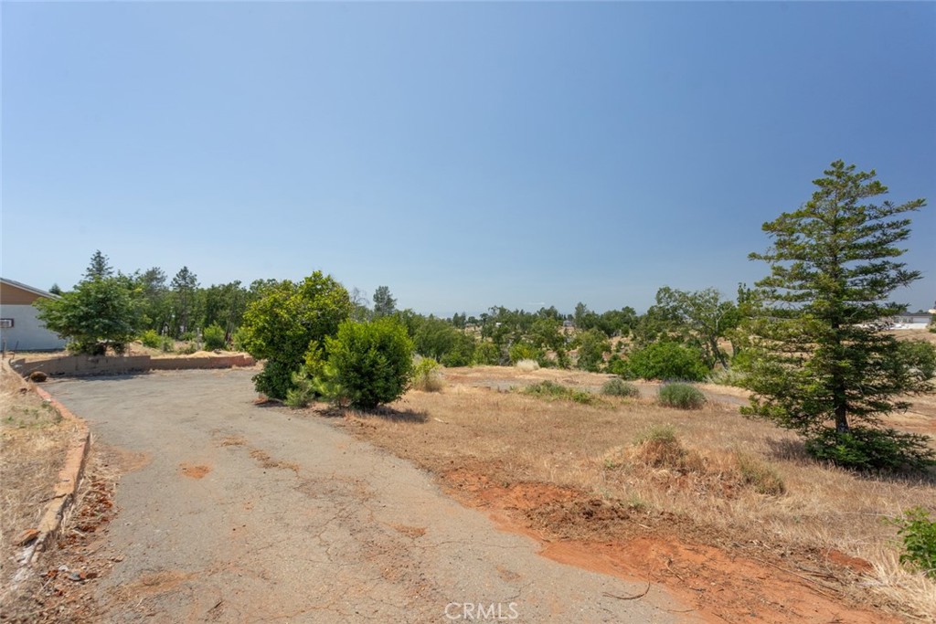 a view of a dirt road with a building in the background