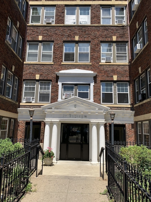 a front view of a brick house with many windows