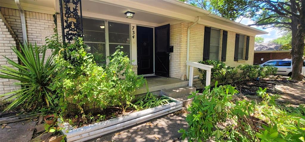 a view of a house with a flower garden