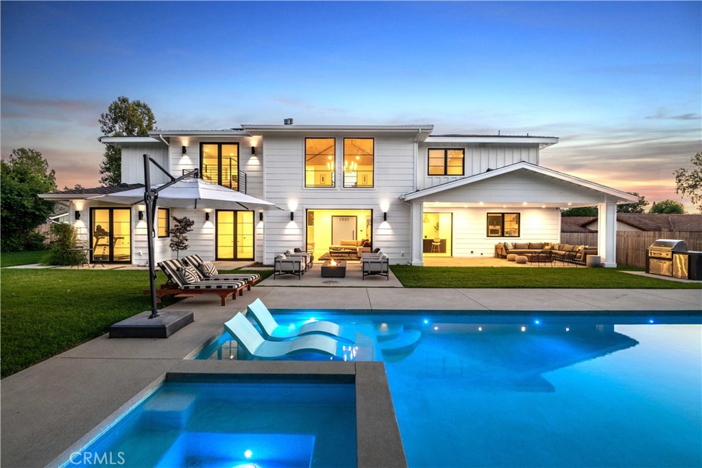 a view of an house with backyard space and balcony