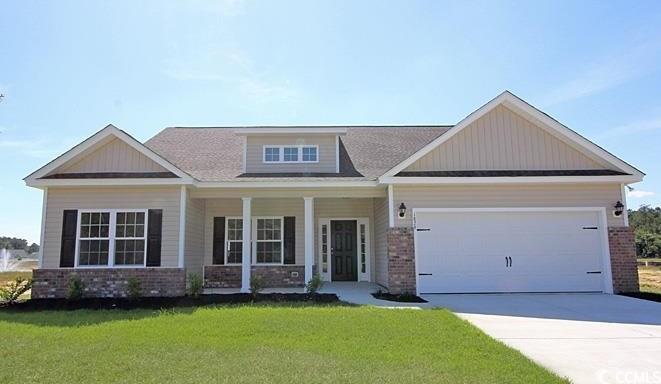 Craftsman inspired home featuring a front lawn, a