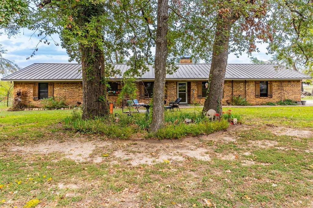 front view of a house with a tree in a yard