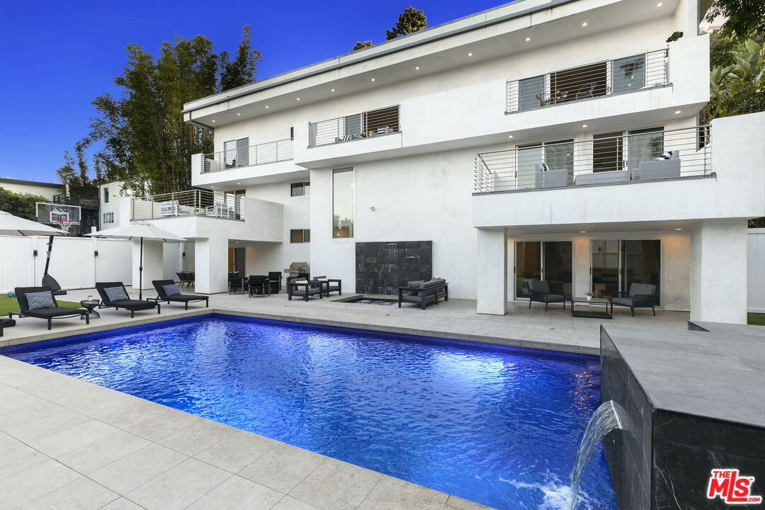 a view of a house with swimming pool in front of it