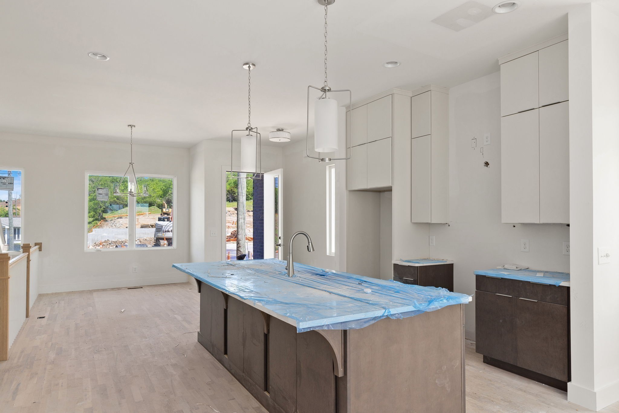 a kitchen with stainless steel appliances granite countertop a sink refrigerator and window