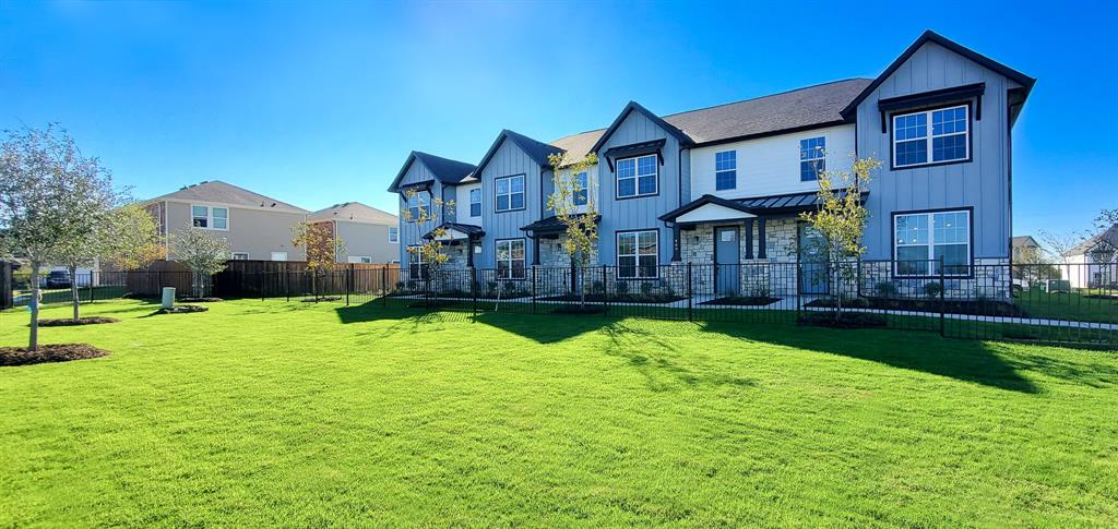 a front view of a house with yard and green space