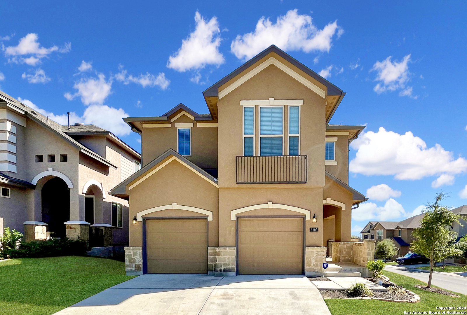 a front view of a house with a yard