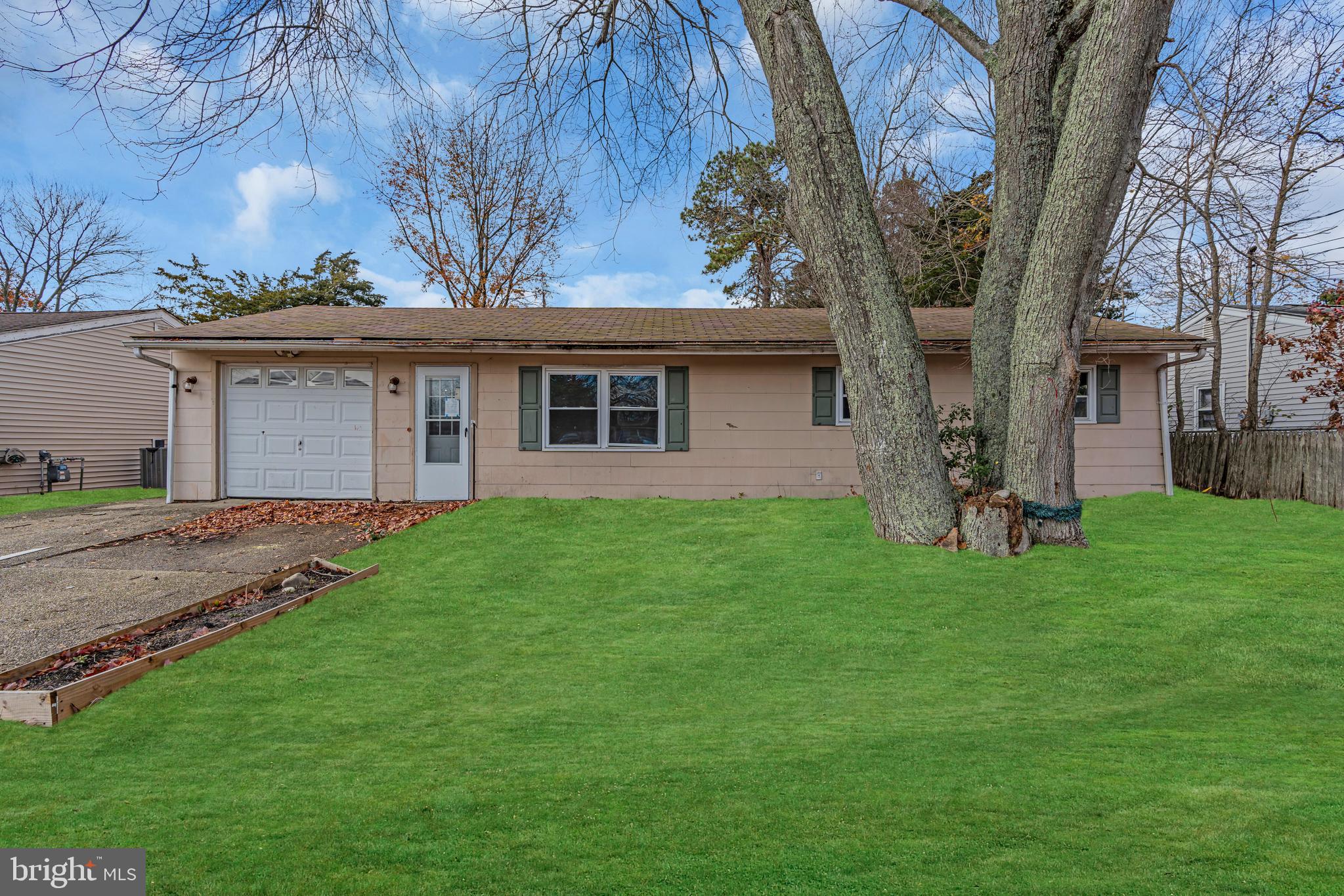 a view of a house with a backyard