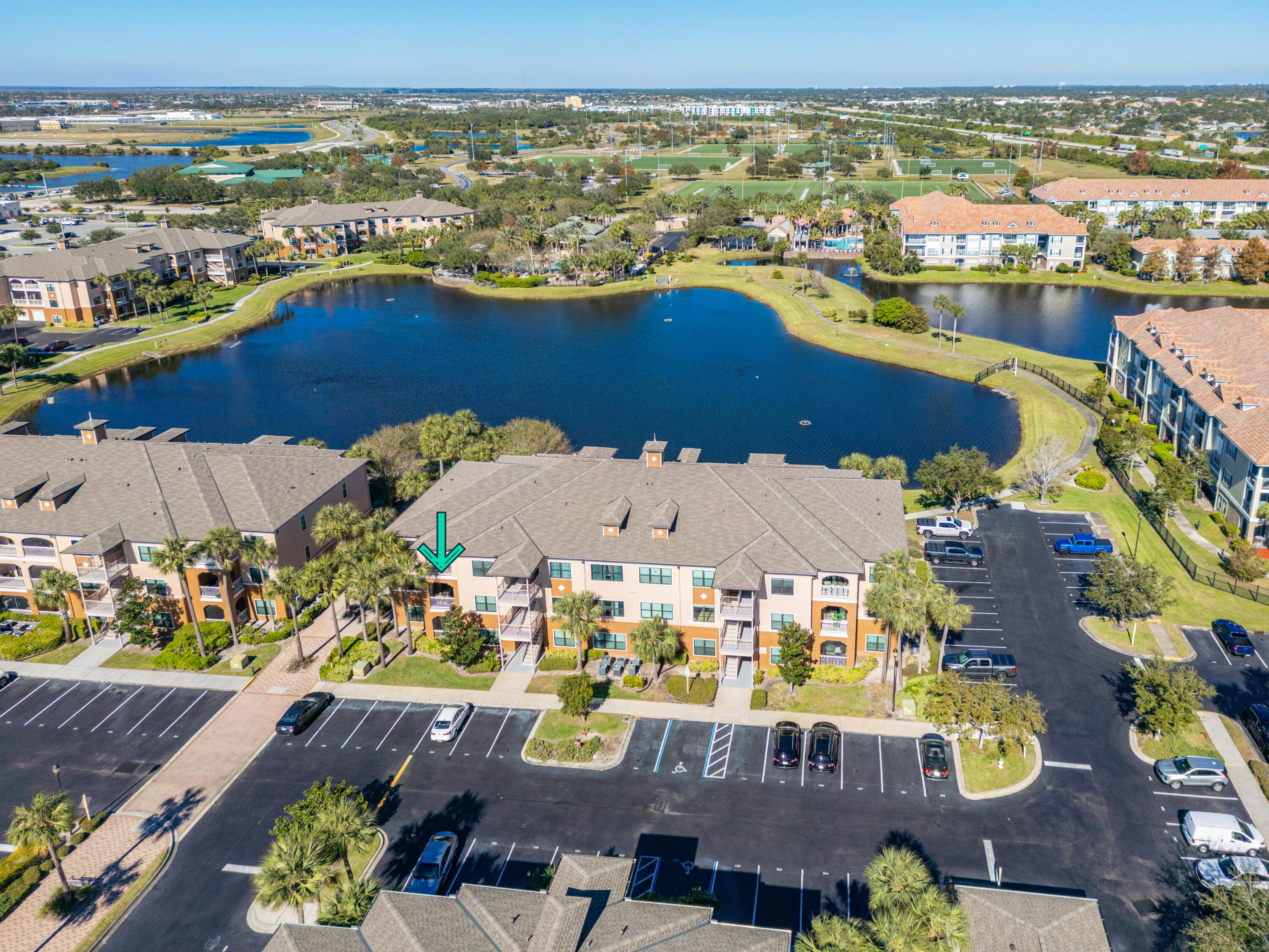 an aerial view of ocean and residential houses with outdoor space