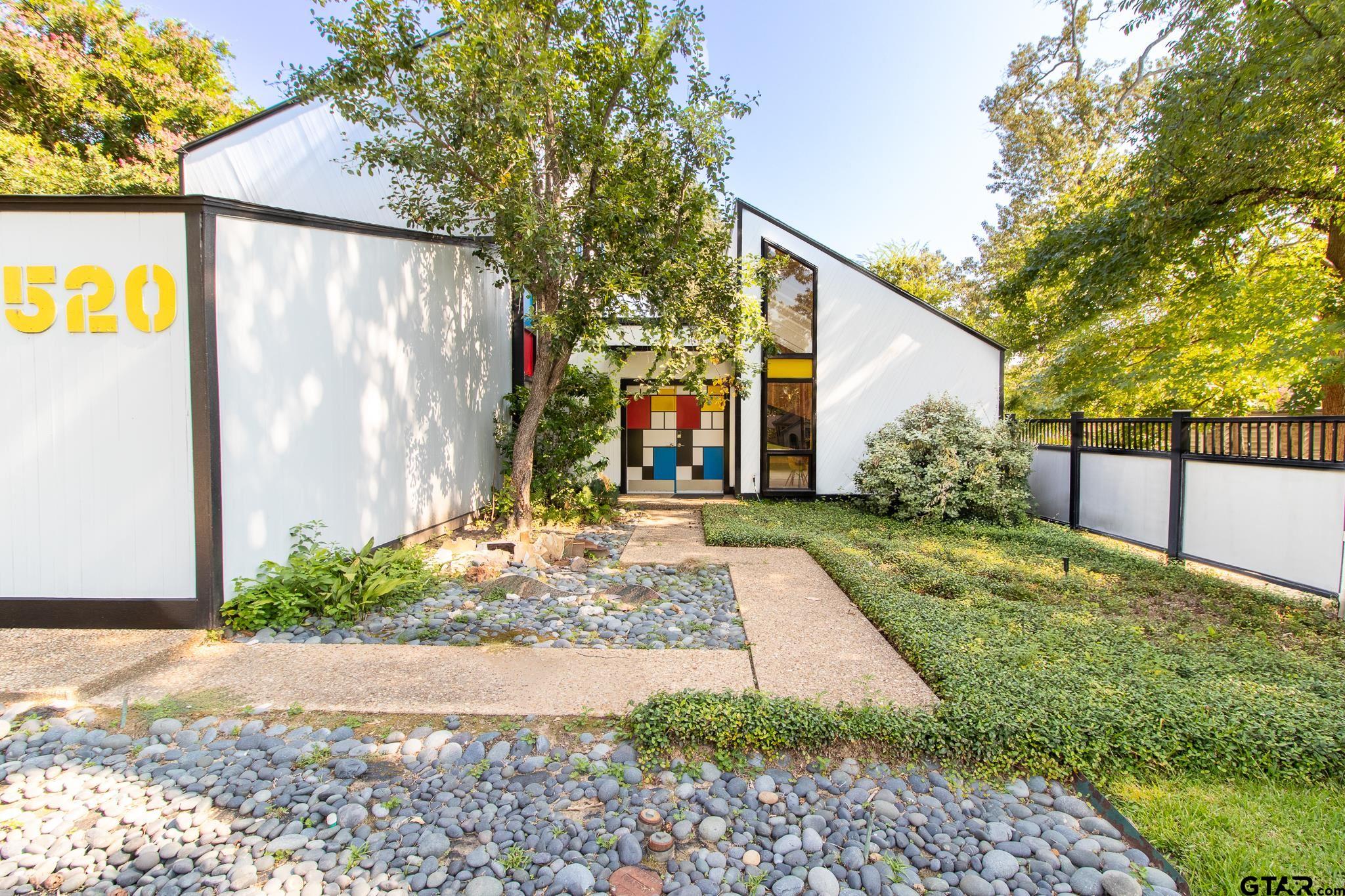 a view of a back yard with yellow house