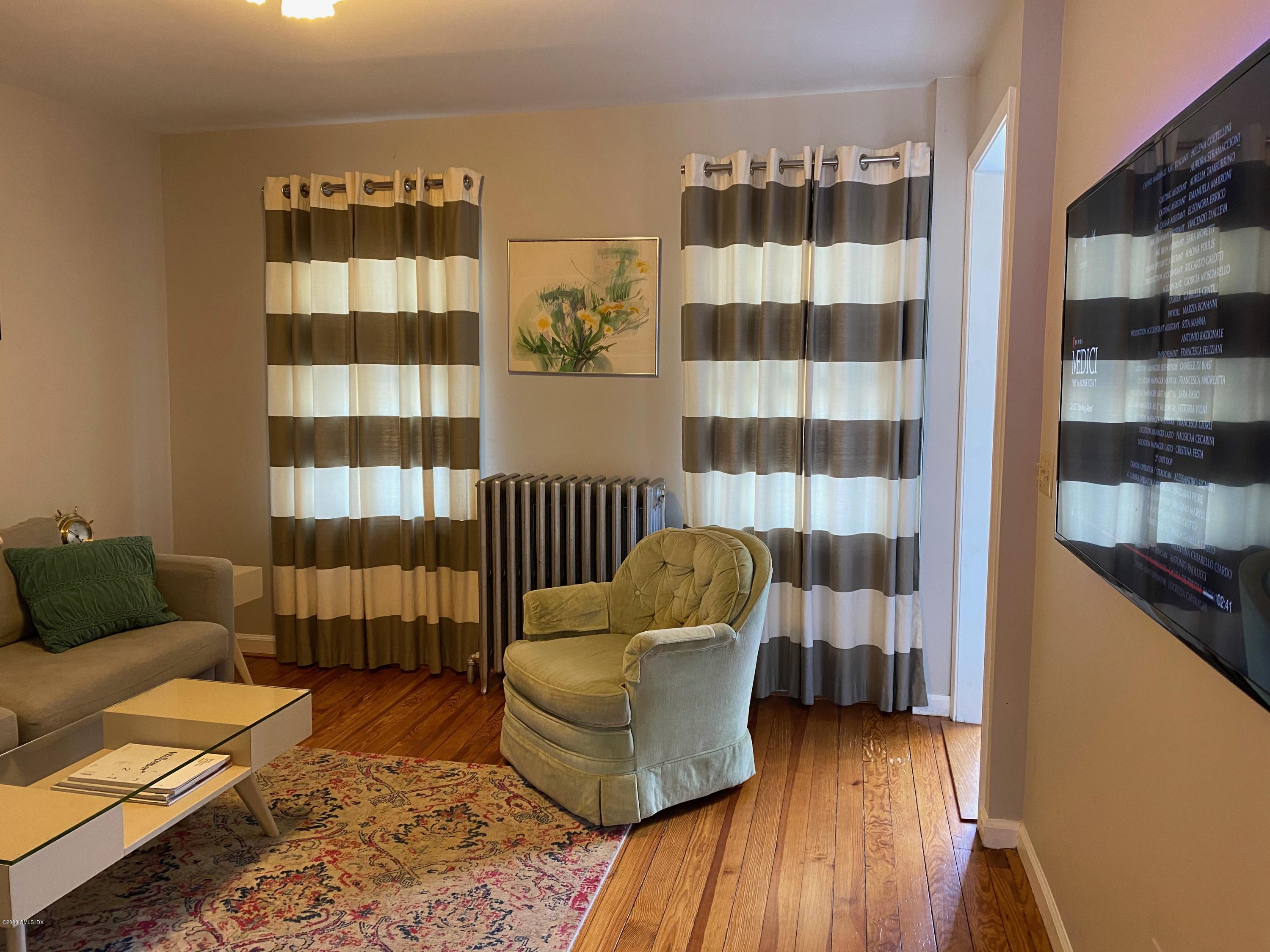 a living room with furniture and a walk in closet