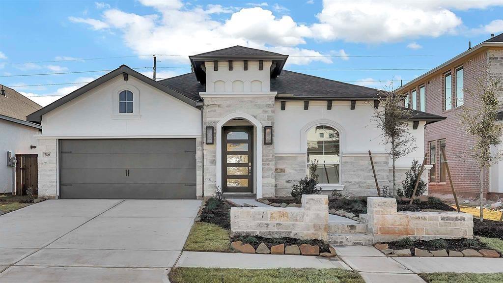 a front view of a house with garage