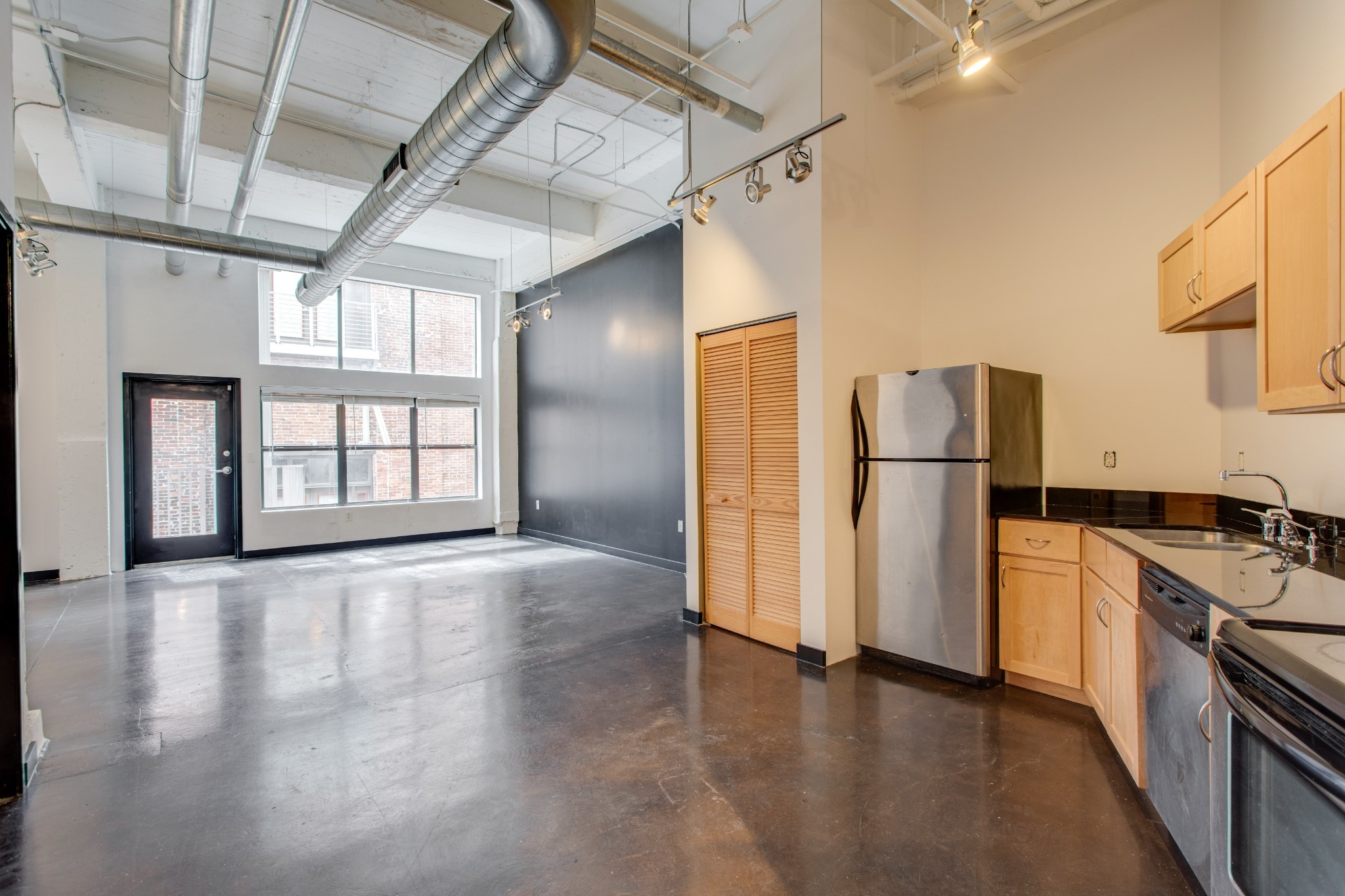 a view of a kitchen with a sink and a refrigerator