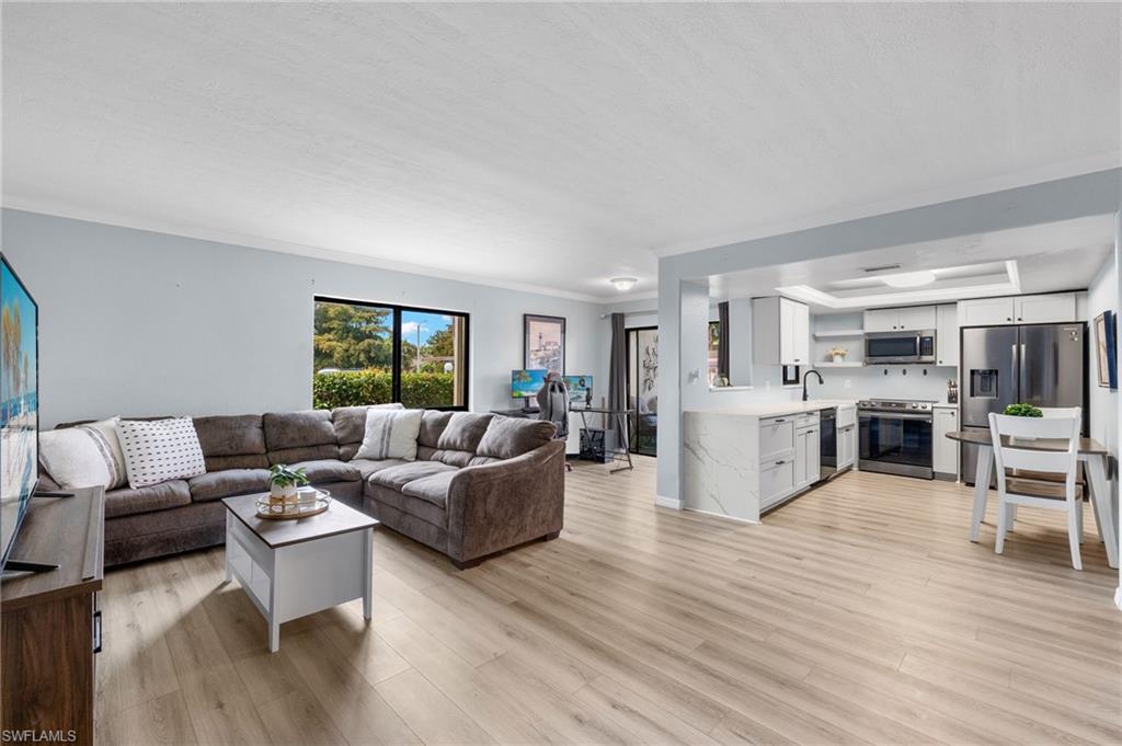 a living room with furniture and kitchen view