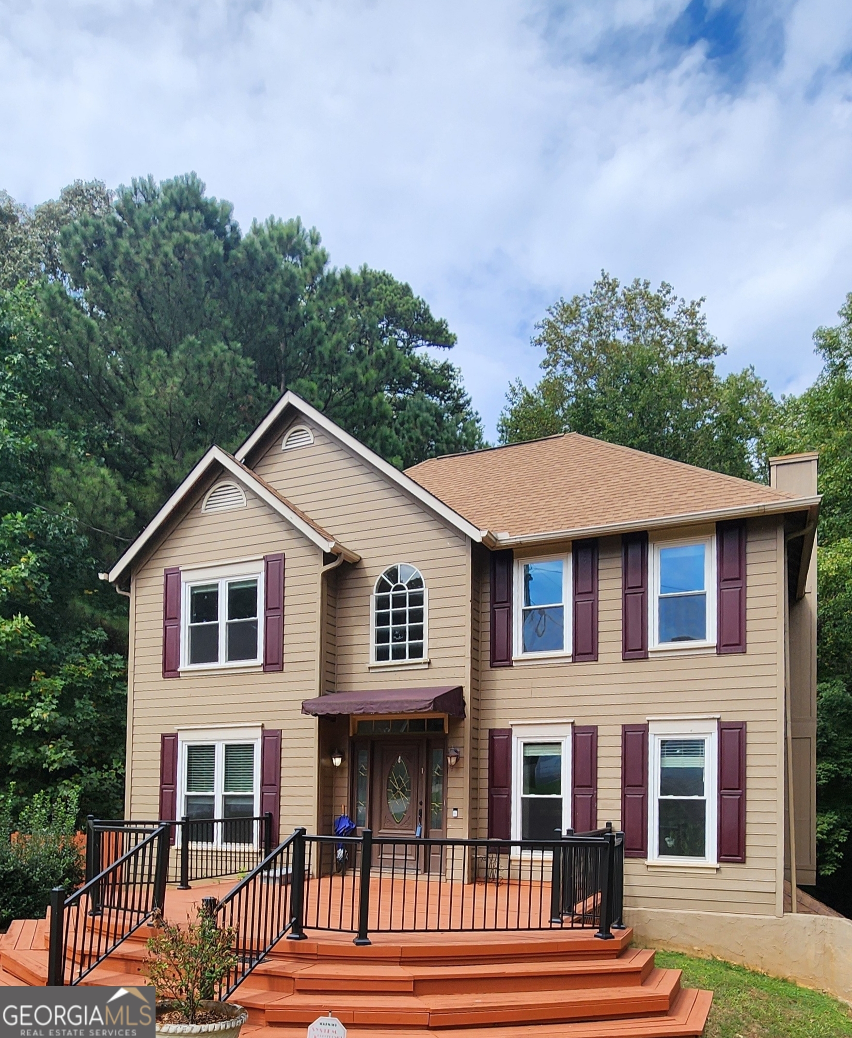 a front view of a house with a garden