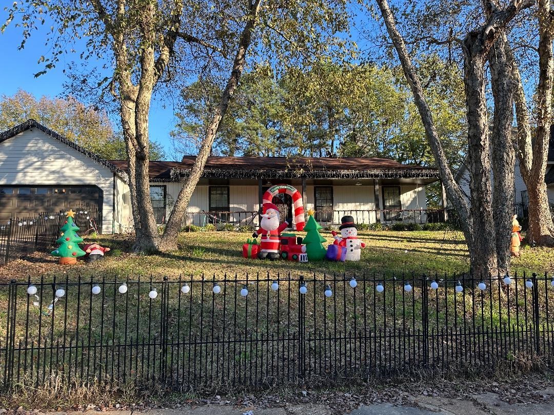 Single story home with a garage and a front lawn