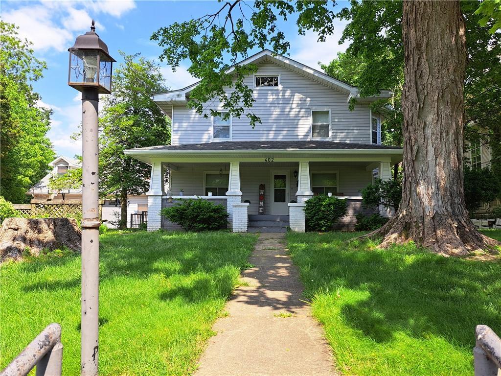 a front view of a house with a yard table and chairs