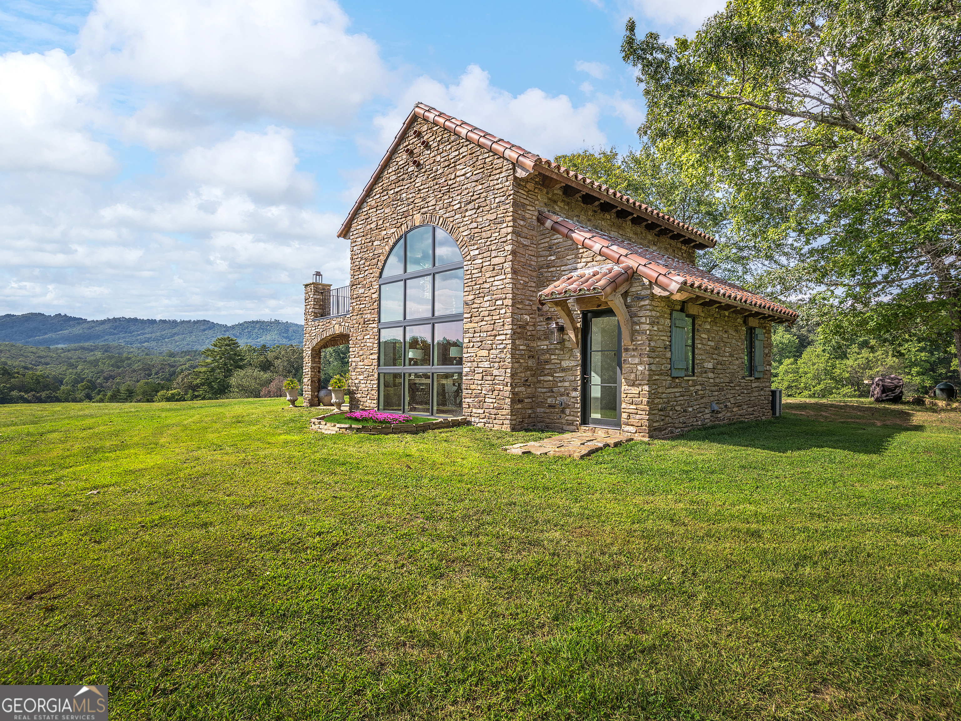 a view of a house with a yard and sitting area