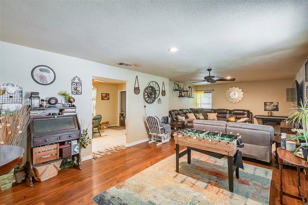 a living room with furniture a rug and wooden floor