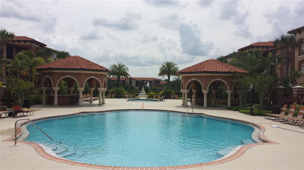 a swimming pool with outdoor seating yard and barbeque oven