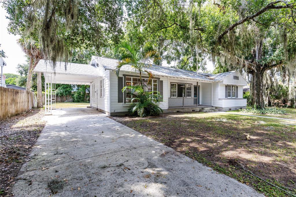 a view of a house with yard and a tree