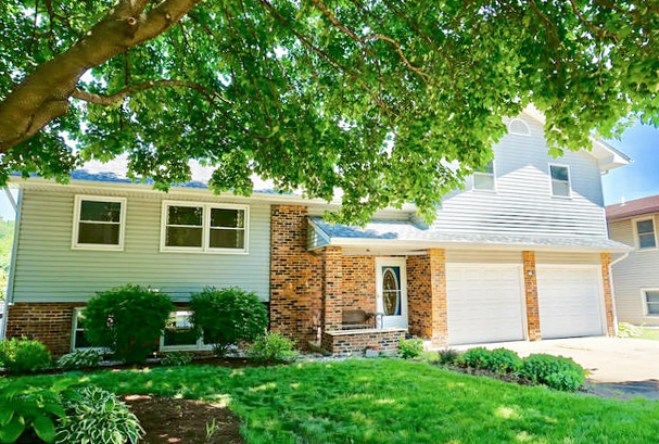 a front view of a house with a yard and porch