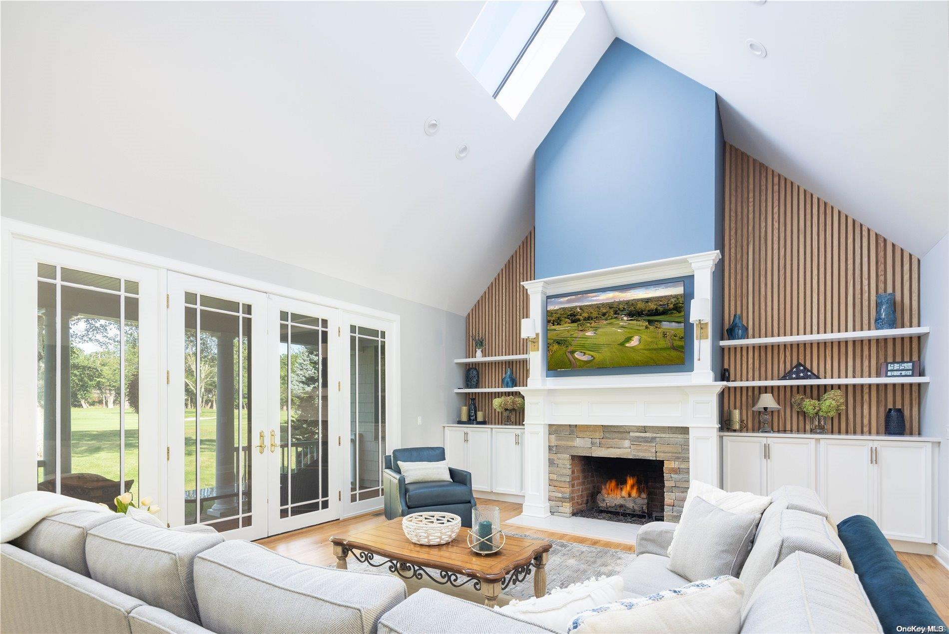 a living room with furniture fireplace and a large window