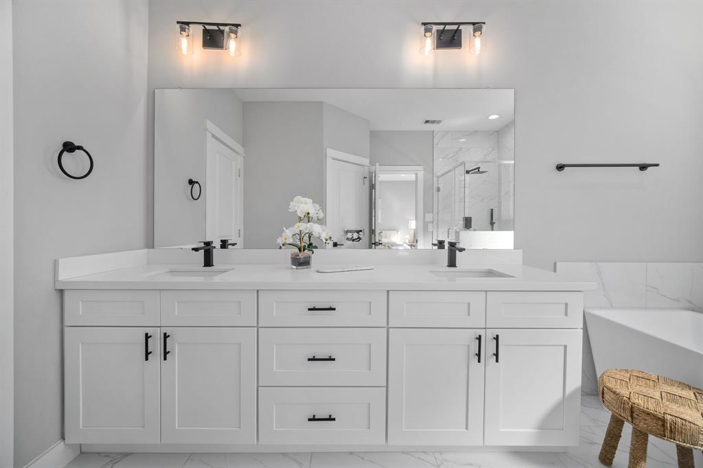 a bathroom with double vanity sink a mirror and vanity