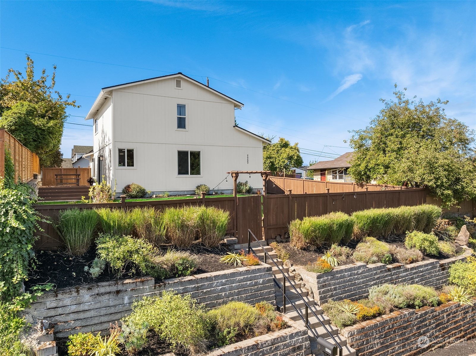 a view of a backyard with plants and a patio