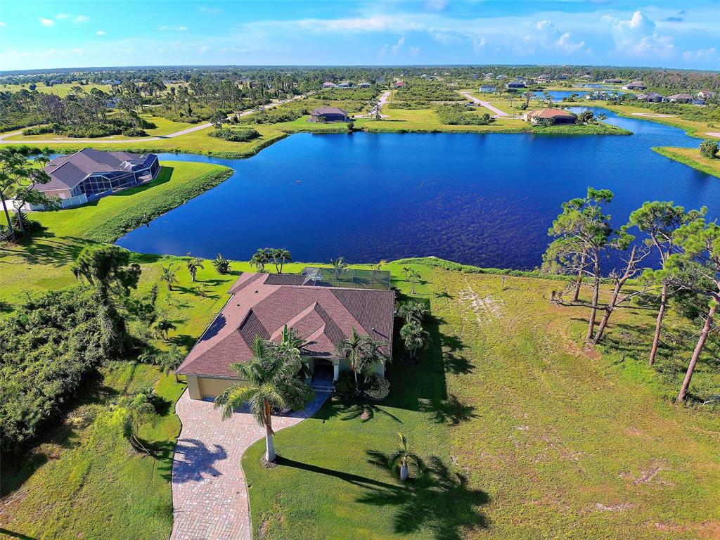 an aerial view of residential houses with outdoor space and swimming pool