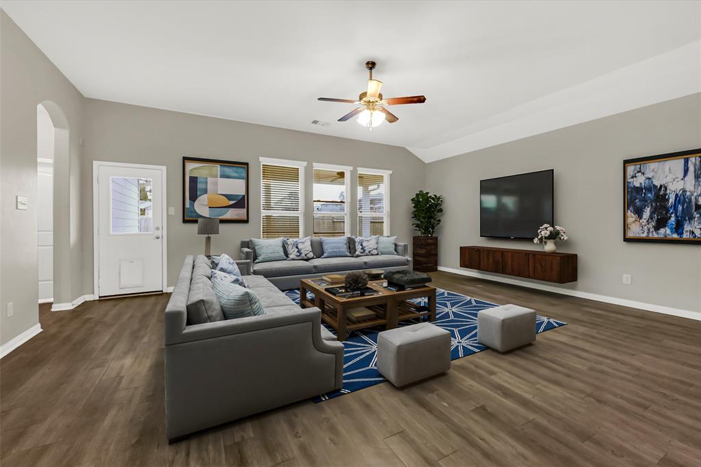 a living room with furniture and a flat screen tv